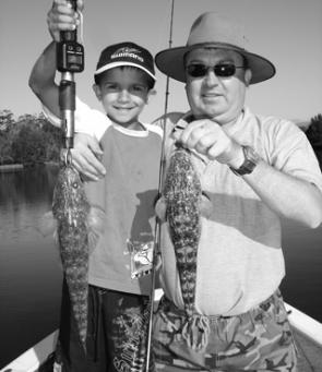 Tommy Maples, 8, with his Dad, Richard, with a couple of Tuross river flatties. It was Tommy’s first time using soft plastics and his smile says it all.